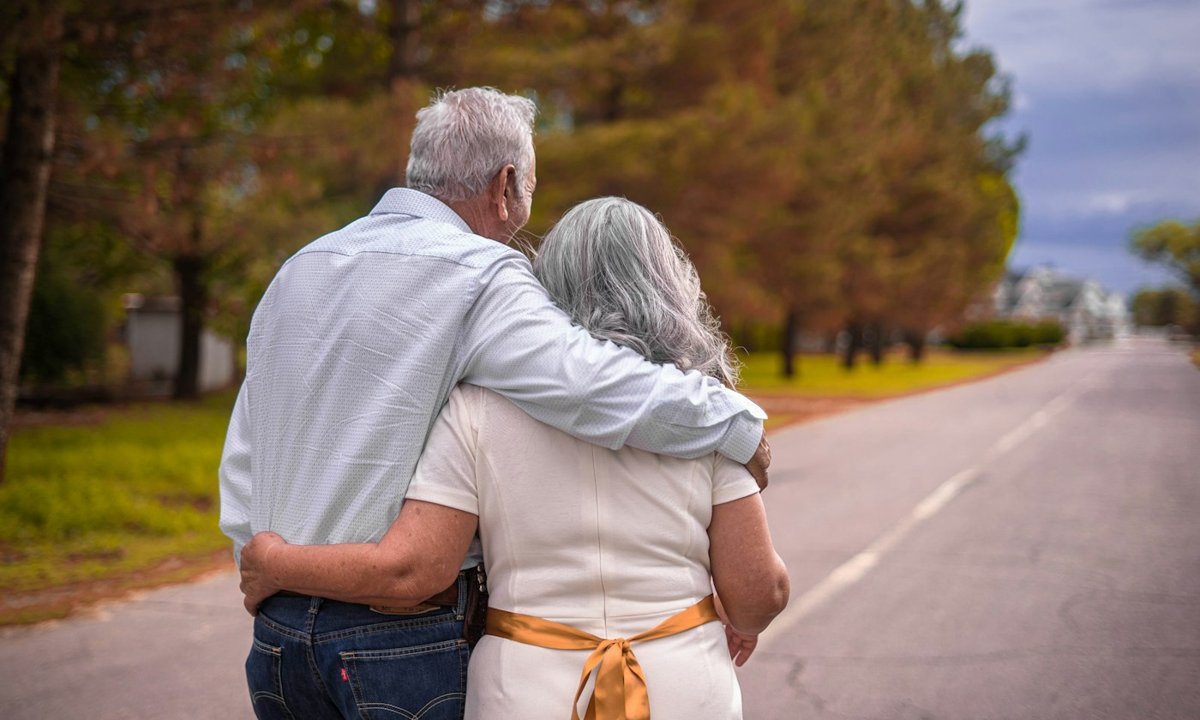 Retired couple walking arm in arm